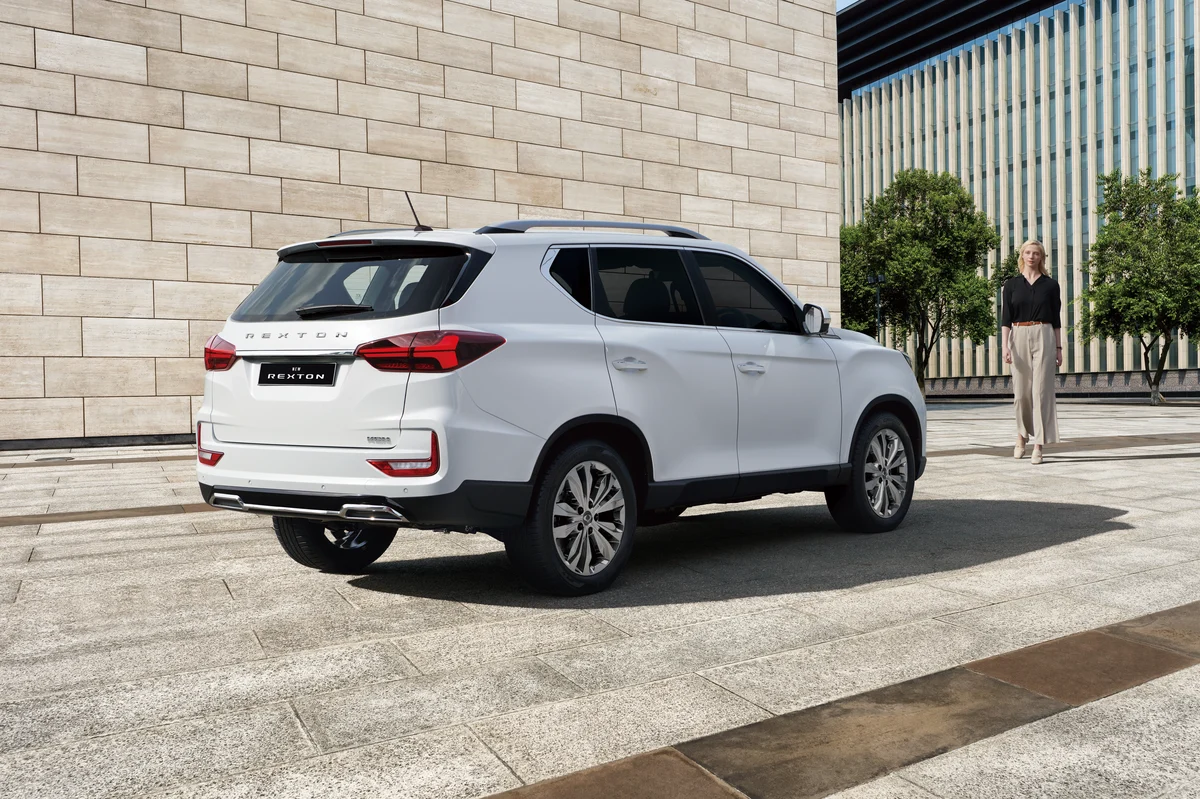 The rear of a white KGM Rexton parked in a paved plaza